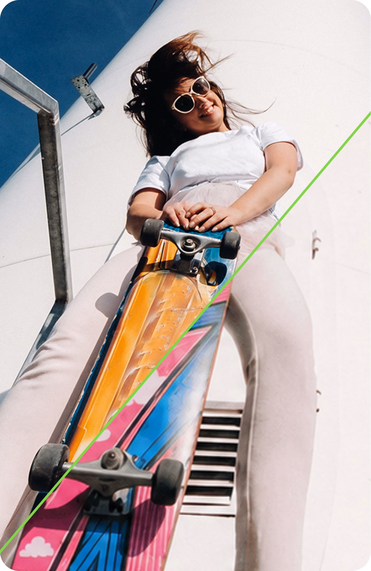 Person holding a skateboard against a colorful wall