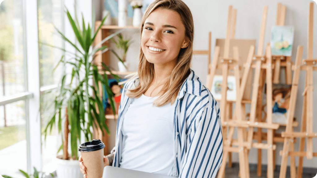 Marketing Manager holding laptop and coffee cup